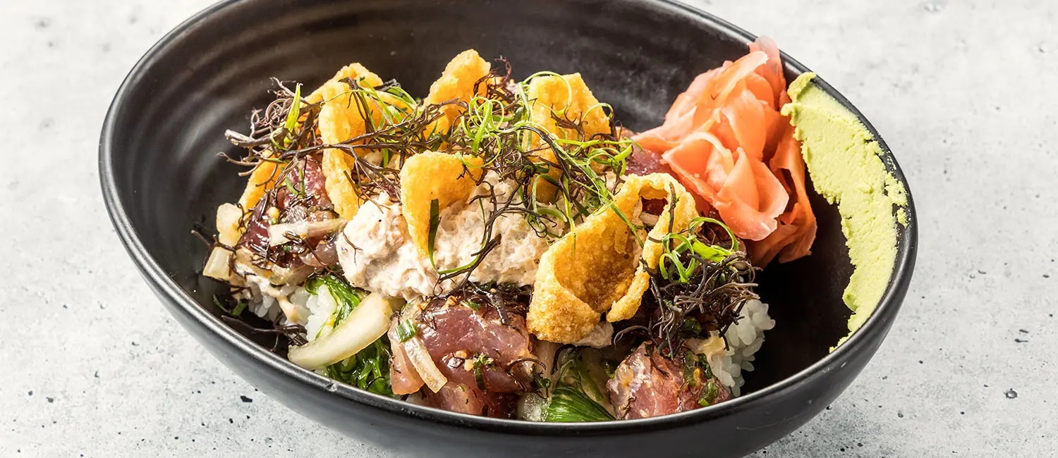 Hawaiian poke bowl topped with various fresh ingredients