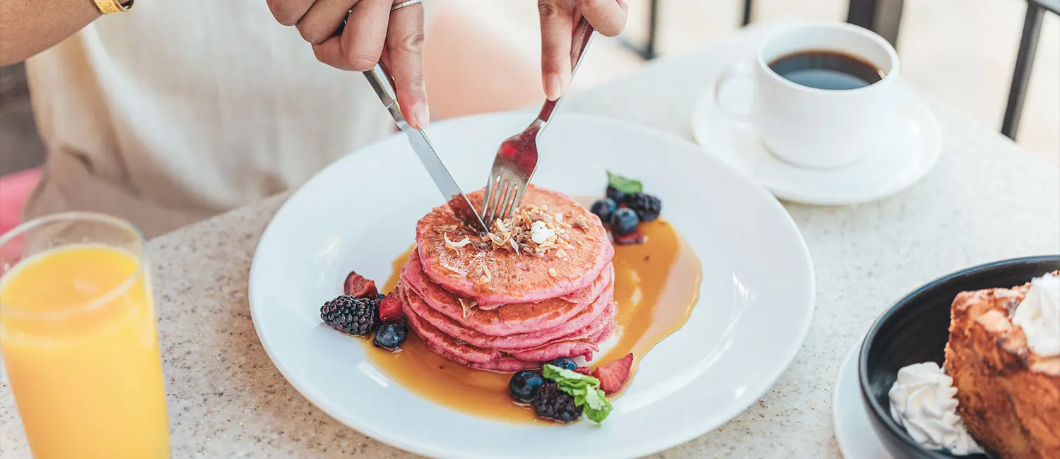 Royal Hawaiian’s signature Pink Palace Pancakes topped with mixed berries and syrup