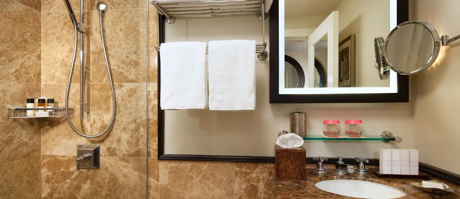 Bathroom featuring shower and vanity area with Malie Organics amenities.