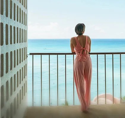 Photo of a lady standing on the balcony