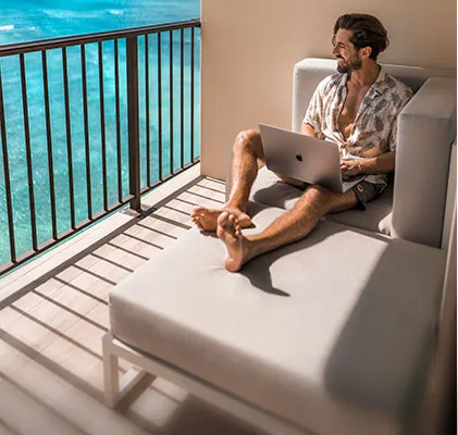 Photo of a man relaxing on the balcony sofa