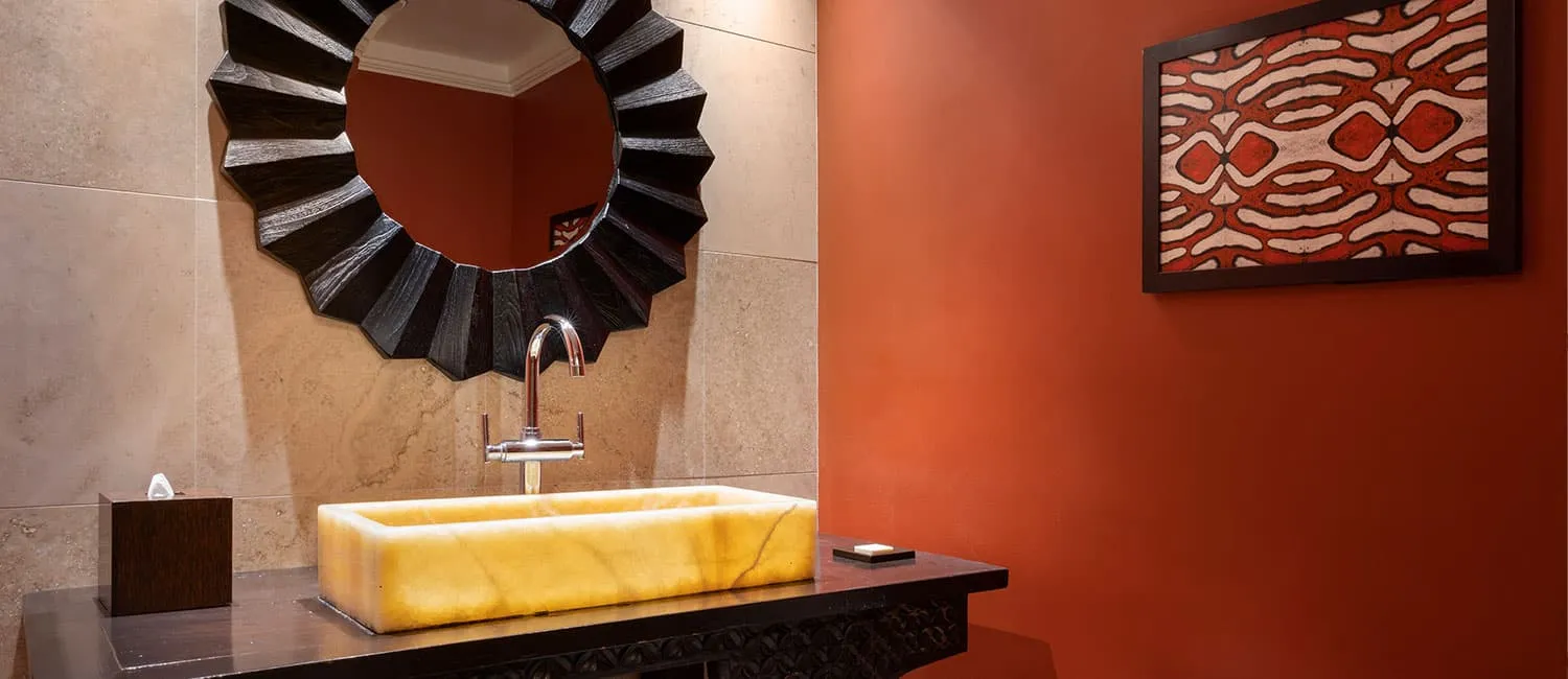 Kamehameha Suite vanity area with warm lighting and elegant design details.